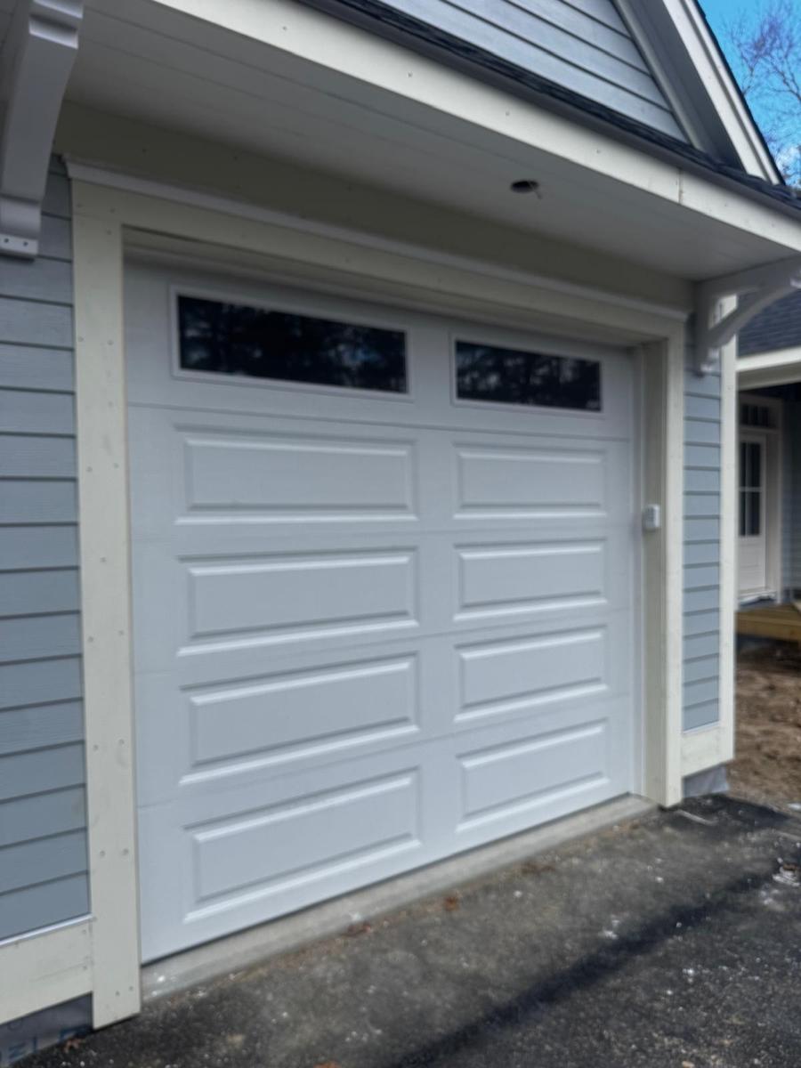 Bluefin single white garage door on gray house exterior